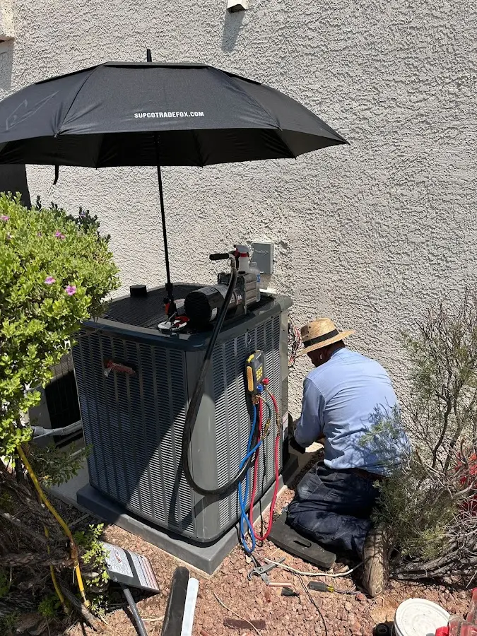 HVAC technician performing outdoor AC maintenance in Glen Rock