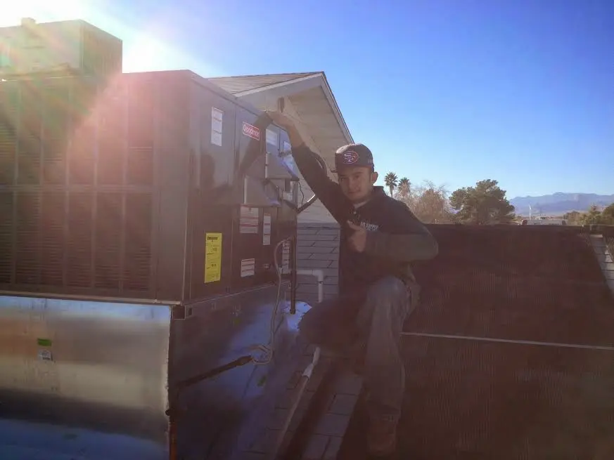 HVAC technician performing Air Duct Cleaning on a rooftop unit in Glen Rock
